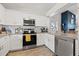 Modern kitchen with white cabinetry, granite countertops, and stainless steel appliances at 7134 2Nd N St, St Petersburg, FL 33702