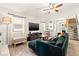 Cozy living room featuring a plush sofa, modern media center, and natural light at 7134 2Nd N St, St Petersburg, FL 33702