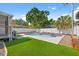 Backyard pool with spa, privacy fence, and artificial turf at 7134 2Nd N St, St Petersburg, FL 33702