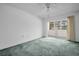Bedroom featuring neutral walls, carpet, and sliding glass doors to the outside at 7321 Central Ave # 203, St Petersburg, FL 33710