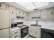 Bright kitchen with ample cabinetry, double sink, and modern appliances, ready for culinary adventures at 7321 Central Ave # 203, St Petersburg, FL 33710