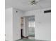 Open living area with green carpet, ceiling fan, and easy access to other rooms in the home at 7321 Central Ave # 203, St Petersburg, FL 33710