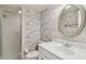 Bathroom with walk-in shower, toilet, and sink with mirror at 8703 Bardmoor Blvd # 203, Seminole, FL 33777