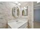 Bathroom with sink, mirror, wall paper and entrance to bedroom at 8703 Bardmoor Blvd # 203, Seminole, FL 33777