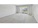 Bright bedroom with neutral carpet, natural light and balcony access at 8703 Bardmoor Blvd # 203, Seminole, FL 33777