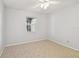 Bedroom showcasing a ceiling fan, neutral carpet, and a window that offers natural light at 8703 Bardmoor Blvd # 203, Seminole, FL 33777