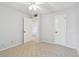 Bedroom featuring neutral carpet, light-colored walls, and a glimpse into an adjacent hallway at 8703 Bardmoor Blvd # 203, Seminole, FL 33777