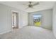 Bedroom featuring a ceiling fan, closet, and view to the outside at 8703 Bardmoor Blvd # 203, Seminole, FL 33777