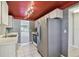 Functional kitchen featuring stainless steel appliances, white cabinets, and a view into the carpeted living area at 8703 Bardmoor Blvd # 203, Seminole, FL 33777