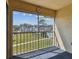 Enclosed patio with screened windows overlooking manicured lawns and a refreshing community pool at 8703 Bardmoor Blvd # 203, Seminole, FL 33777