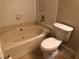 Bright bathroom with a soaking tub, tiled walls, and a tile floor at 10114 Winsford Oak Blvd # 517, Tampa, FL 33624