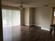 Living room with laminate flooring and sliding glass doors that provide natural light at 10114 Winsford Oak Blvd # 517, Tampa, FL 33624