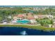 Expansive community center with a large pool, lake views, and lush landscaping in a resort-style setting at 1102 Emerald Dunes Dr, Sun City Center, FL 33573