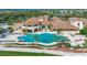 Aerial view of a community center with a pool, lush landscaping, and amenities for residents enjoyment at 1102 Emerald Dunes Dr, Sun City Center, FL 33573