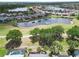 Aerial view of a community with a golf course, multiple ponds, and lush landscaping at 1102 Emerald Dunes Dr, Sun City Center, FL 33573