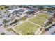 Expansive aerial view showcasing a community center with parking, lawn bowling, and other amenities at 1102 Emerald Dunes Dr, Sun City Center, FL 33573