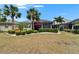 Beautiful backyard featuring manicured landscaping, privacy hedges, and a screened lanai for outdoor enjoyment at 1102 Emerald Dunes Dr, Sun City Center, FL 33573