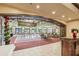 Spacious ballroom featuring elegant chandeliers, a dance floor, and festive holiday decorations at 1102 Emerald Dunes Dr, Sun City Center, FL 33573