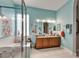 Bright bathroom with a double sink vanity, glass shower, and an abundance of natural light at 1102 Emerald Dunes Dr, Sun City Center, FL 33573