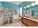 Bright bathroom featuring double vanity, soaking tub, and separate glass shower at 1102 Emerald Dunes Dr, Sun City Center, FL 33573