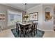 Well-lit dining room with a dark wood table, seating for six, and a large window at 1102 Emerald Dunes Dr, Sun City Center, FL 33573