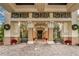 Grand entrance with detailed columns, covered walkway, and seasonal decor for an inviting arrival experience at 1102 Emerald Dunes Dr, Sun City Center, FL 33573