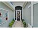 Inviting front entry with decorative accents and a secure, stylish screen door enhancing curb appeal at 1102 Emerald Dunes Dr, Sun City Center, FL 33573