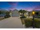 Charming single-story home with a well-manicured lawn, mature palm trees, and a welcoming two-car garage at 1102 Emerald Dunes Dr, Sun City Center, FL 33573