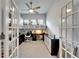 Bright home office featuring custom built-ins, neutral decor, and modern ceiling fan at 1102 Emerald Dunes Dr, Sun City Center, FL 33573