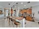 Charming kitchen with a breakfast bar, wooden cabinetry, and modern appliances at 1102 Emerald Dunes Dr, Sun City Center, FL 33573