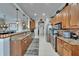 Bright kitchen featuring granite countertops, wood cabinets, and stainless steel appliances at 1102 Emerald Dunes Dr, Sun City Center, FL 33573