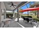 Inviting screened lanai with ample seating, ceiling fan, and views of the landscaped backyard for relaxing at 1102 Emerald Dunes Dr, Sun City Center, FL 33573