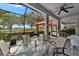 Beautiful screened-in lanai with ample seating for dining and relaxing, overlooking manicured landscaping at 1102 Emerald Dunes Dr, Sun City Center, FL 33573