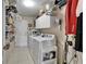 Functional laundry room with washer, dryer, storage cabinets, and ample shelving at 1102 Emerald Dunes Dr, Sun City Center, FL 33573