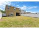 Spacious backyard with a well-maintained lawn, enclosed by a white privacy fence and view of the back of the house at 1210 Trailwater St, Ruskin, FL 33570