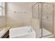 Stylish bathroom features a tub and shower with neutral tiling and granite countertop at 1210 Trailwater St, Ruskin, FL 33570