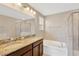 Dual sink vanity, soaking tub, and glass enclosed shower in a spacious bathroom at 1210 Trailwater St, Ruskin, FL 33570