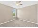 Empty carpeted bedroom with a ceiling fan and window for natural light at 1210 Trailwater St, Ruskin, FL 33570