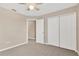Carpeted bedroom featuring a ceiling fan, neutral paint, and double-door closet at 1210 Trailwater St, Ruskin, FL 33570