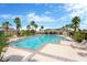 Resort-style community pool with lounge chairs, lush landscaping, and clear blue water at 1210 Trailwater St, Ruskin, FL 33570