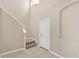 Bright entryway features a tiled floor, neutral paint, and staircase to the second level at 1210 Trailwater St, Ruskin, FL 33570