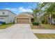 Charming home with a well-manicured lawn, mature tree, and a two-car garage at 1210 Trailwater St, Ruskin, FL 33570