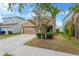 Charming home with a well-manicured lawn, mature tree, and a two-car garage at 1210 Trailwater St, Ruskin, FL 33570
