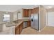 Kitchen featuring stainless steel appliances, granite countertops, and dark wood cabinets at 1210 Trailwater St, Ruskin, FL 33570