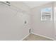Bright laundry room featuring tile flooring, window, and a utility sink at 1210 Trailwater St, Ruskin, FL 33570