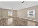 Bright living room with wood-style flooring, two large windows and ceiling fan at 1210 Trailwater St, Ruskin, FL 33570