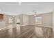 Open-concept living room with tile and wood flooring and sliding glass doors at 1210 Trailwater St, Ruskin, FL 33570