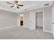 Spacious main bedroom featuring a ceiling fan, tray ceiling, with an ensuite bathroom and walk-in closet at 1210 Trailwater St, Ruskin, FL 33570