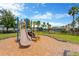 Community playground featuring a slide, climbing structures, and cushioned ground cover at 1210 Trailwater St, Ruskin, FL 33570