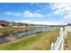 Picturesque water view from backyard featuring houses and blue sky with white, puffy clouds at 1210 Trailwater St, Ruskin, FL 33570